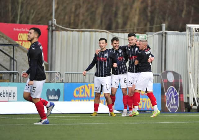 Anton Dowds is mobbed by his teammates after scoring on his return to the side after a loan spell at Arbroath (Pictures by Alan Murray)