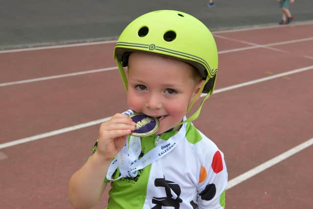 Falkirk Junior Bike Club presented Ché with a medal at the end of his lap.  Pic: Michael Gillen