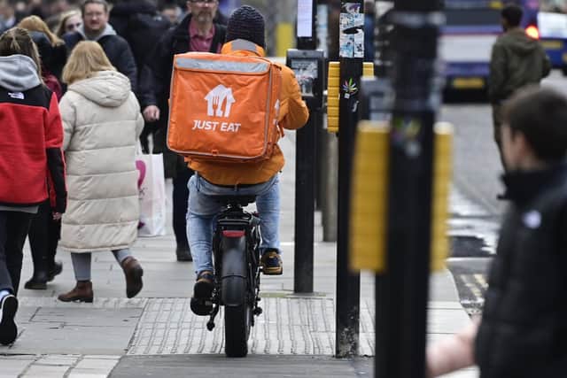 A delivery rider on an e-bike on a pavement in Glasgow city centre. (Pic. John Devlin.)