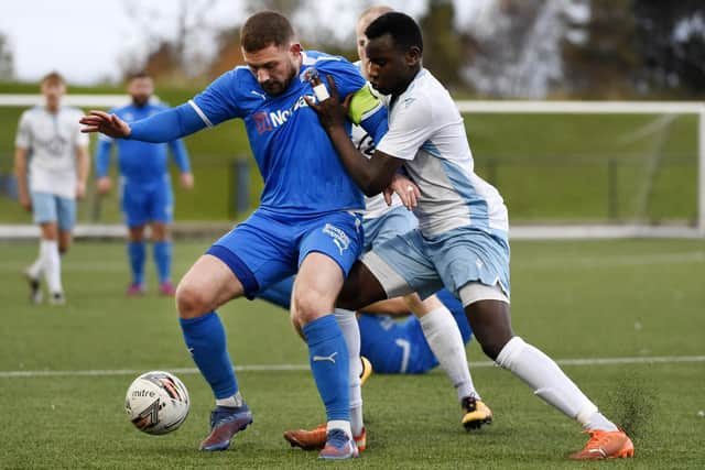 Athletic captain Jason Mackay shields the ball against Edinburgh College