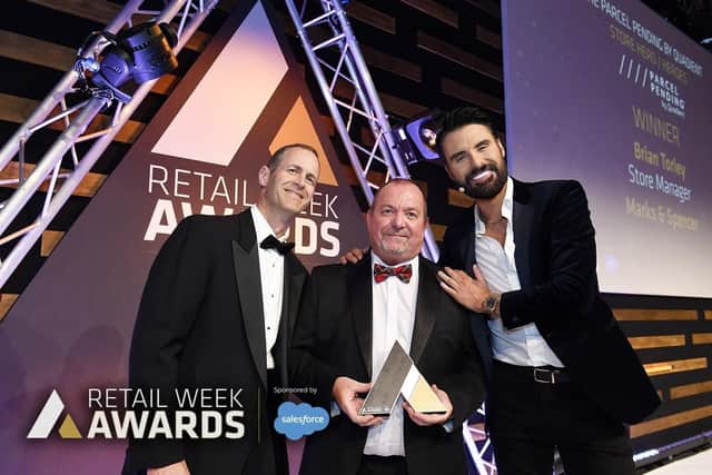 Falkirk M&S manager Brian Torley receives his award from television personality Rylan