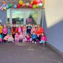 Pupils and staff at St Margaret's Primary School in Polmont have rallied round Jack Robinson (centre, wearing orange and black top) in support of Muscular Dystrophy UK's Go Bright campaign. Contributed.