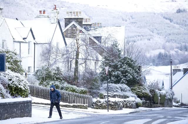 A man walks through the snow in Killin, Stirlingshire