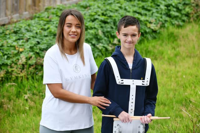Luke Baillie, 12, and mum Emma scaled Ben Nevis to raise funds for Falkirk Schools pipe band. Luke played the drums at the summit of Ben Nevis. Pic: Michael Gillen