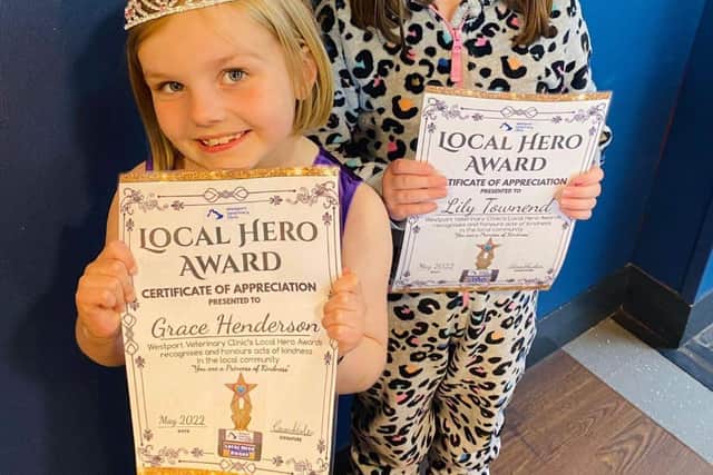 Local Heroes Grace Henderson (blonde) and Lily Townend (brunette) with their hero award certificates.