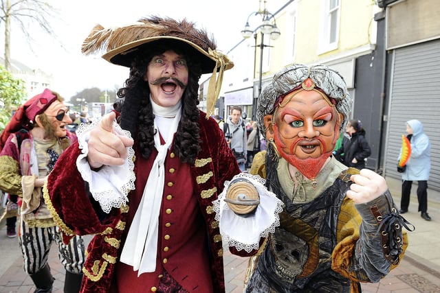 Captain Barbossa and one of his crew stride up the High Street.