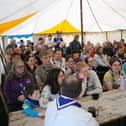 Everyone gathers in the tent on the first evening to hear all about the weekend.