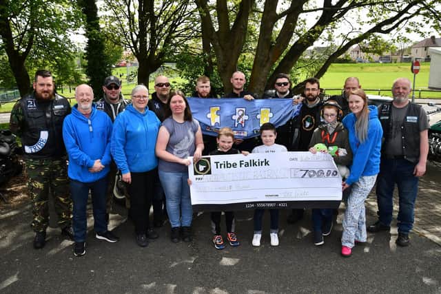Tribe Falkirk hand over the £700 they raised for Falkirk Autistic Bairns