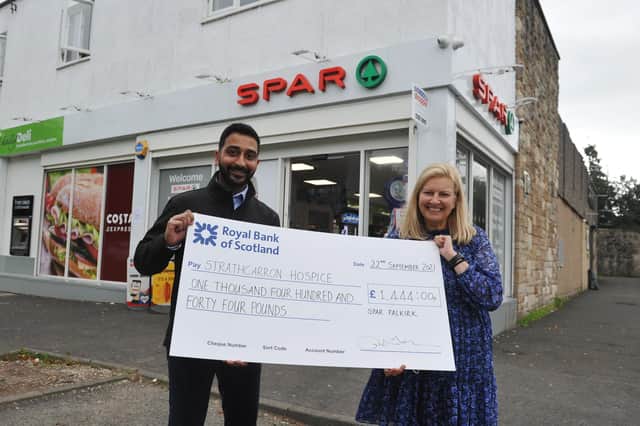 Anand Cheema, owner of SPAR in Maggie Wood’s Loan, Falkirk, presents a cheque for £1444 to Marion Blaney, Strathcarron Hospice's community campaign coordinator. Picture: Michael Gillen.