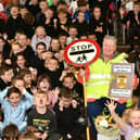 Lollipop lady Catherine Burton is presented with a book of cards from every pupil at Kinneil Primary as she retires after 34 years. Pic: Michael Gillen