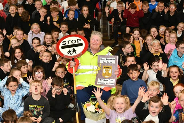 Lollipop lady Catherine Burton is presented with a book of cards from every pupil at Kinneil Primary as she retires after 34 years. Pic: Michael Gillen