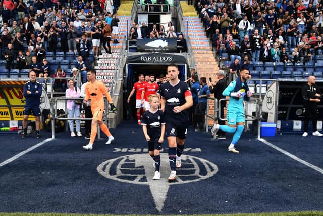 Captain Stephen McGinn leads the side out onto the pitch