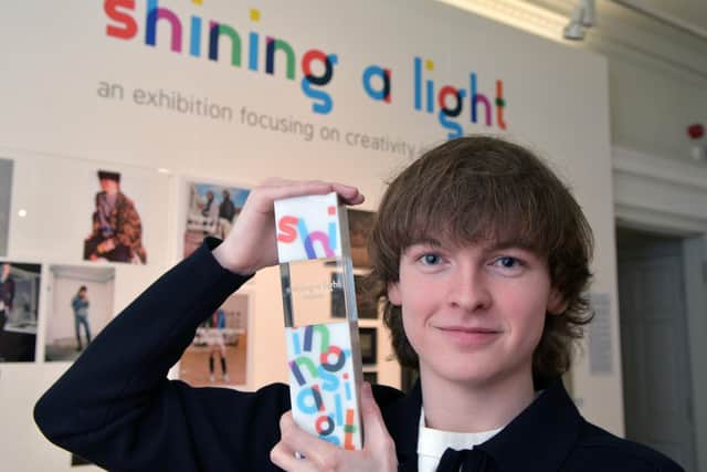 Connor Draycott with his Shining a Light winner trophy designed by Eden Consultancy in Falkirk