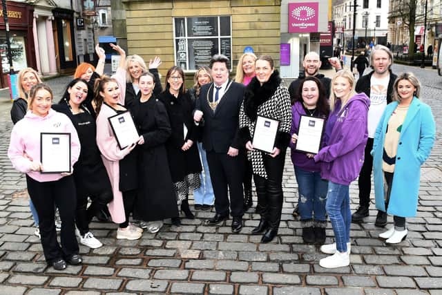 Representatives from the top 10 businesses voted for by members of the public as their most loved businesses within the town centre.  (Pic: Michael Gillen)