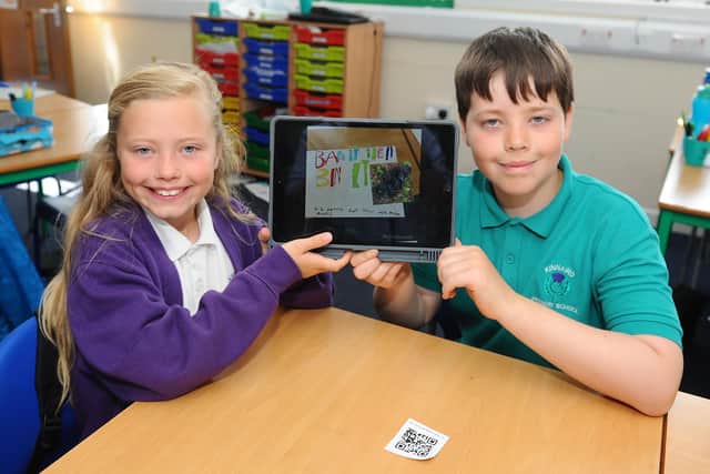 Kinnaird Primary School pupils Jorgie Robertson and Jack Lamont, both aged nine, display information about P5L's campaign on litter. Picture: Michael Gillen.