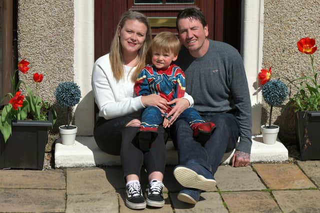 Superhero fan Murray Young (2) with mum Lauren and dad Marc