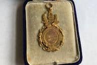Dux medal for Falkirk High School from 1912. Awarded to Robert J. Wedderspoon. Found in a house in Horsham, West Sussex in 2021.