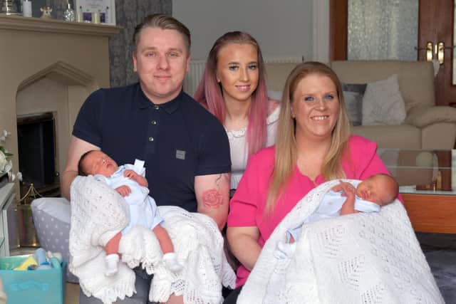 Vicky Redding (35), partner Paul Ure (36) with twins Franky Ure, left, and Harry Ure, along with big sister Samantha Redding (14) - photograph taken through the window of their Ladysmill home by photographer Michael Gillen
