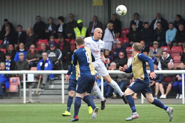 Michael Gemmell jumps up for a header