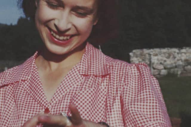 An image taken from the video 'Elizabeth: The Unseen Queen' of then Princess Elizabeth showing off her new engagement ring soon after Prince Philip's marriage proposal at Balmoral in 1946 (The Royal Collection via BBC Studios via AP)