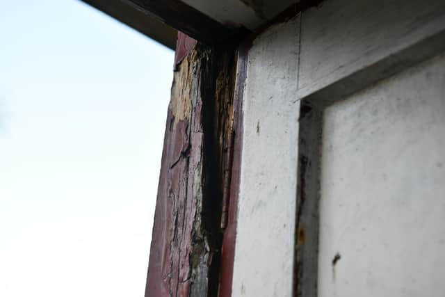 Problems with the property include faulty window, knife marks on a window frame, a broken down pipe and damp outhouse.