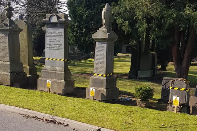 Warning signs and tape on gravestones in Camelon Cemetery