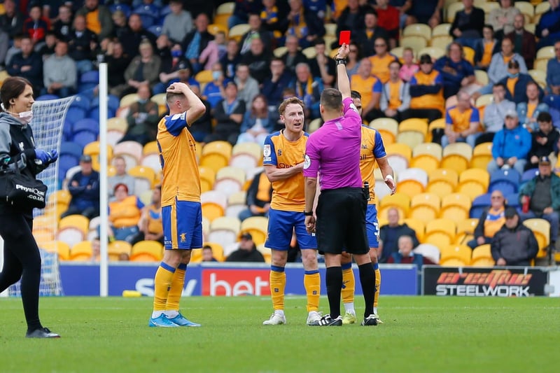Referee Paul Howard issues Mansfield Town midfielder Stephen Quinn a red card.