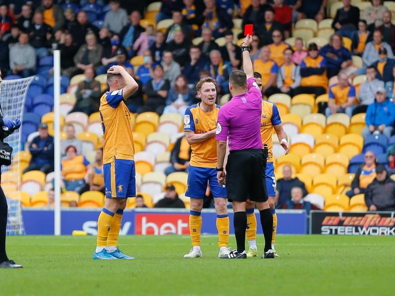 Referee Paul Howard issues Mansfield Town midfielder Stephen Quinn a red card.