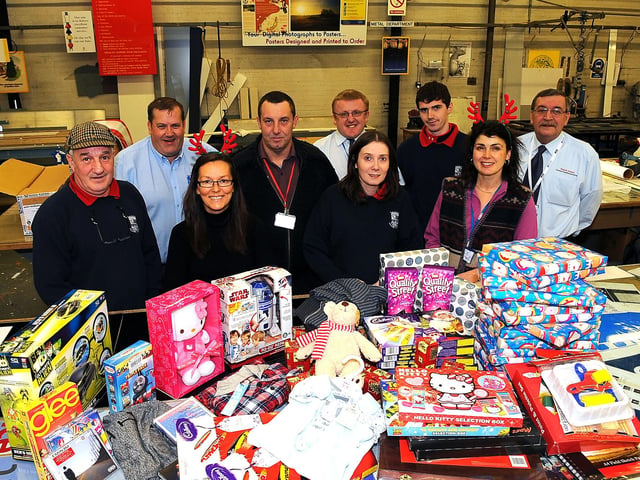 Falkirk Bankside. The Sign Factory. Joy For Toys charity wrapping Christmas presents to give to Shelter, 2010.