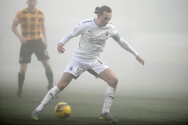 Aidan Nesbitt controls the ball in the foggy conditions (Pic: Michael Gillen)