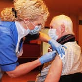 NHS Forth Valley's COVID-19 immunisation programme kicks off in Falkirk Town Hall with staff nurse Tracey McGregor administering the Pfizer-BioNTech Covid-19 vaccine to Camelon resident John Shepherd (82)