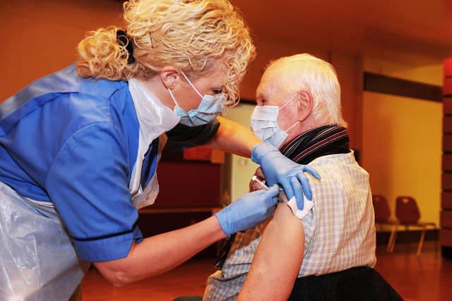 NHS Forth Valley's COVID-19 immunisation programme kicks off in Falkirk Town Hall with staff nurse Tracey McGregor administering the Pfizer-BioNTech Covid-19 vaccine to Camelon resident John Shepherd (82)