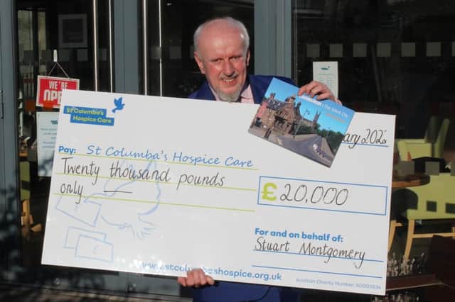 Stuart Montgomery with the cheque for £20,000 he raised for St Columbas' Hospice