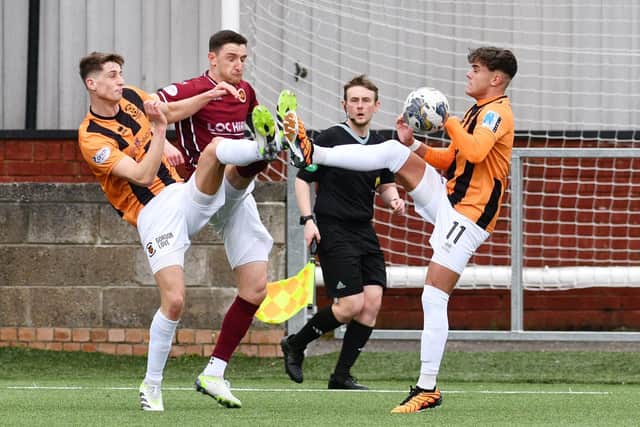 Stenny's Ross Meechan goes for the ball up against East Fife duo Liam Newton and Jack Healy.