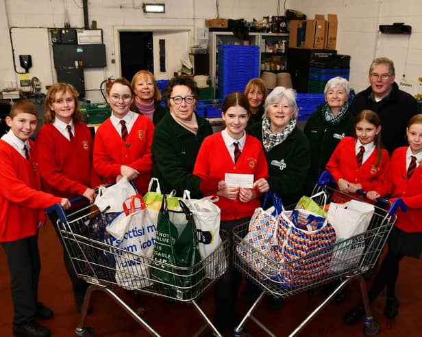 St Francis Xavier's RC Primary School, Faith and Action group handing over a cheque for £150 they raised doing various activities. Pic: Michael Gillen