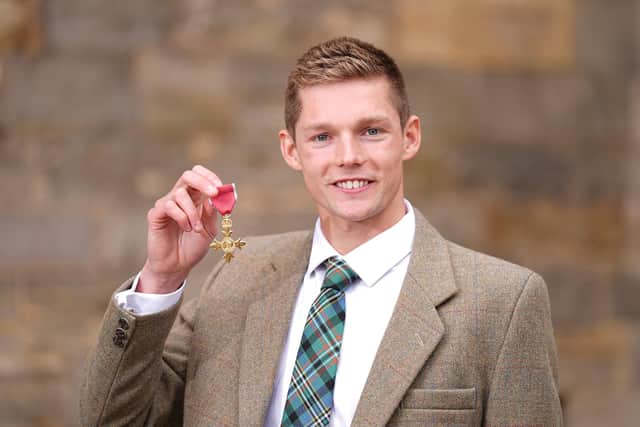 Ex-FIRST swimmer Duncan Scott with his medal after being appointed an Officer of the Order of the British Empire (Photo: Aaron Chown/Getty Images)