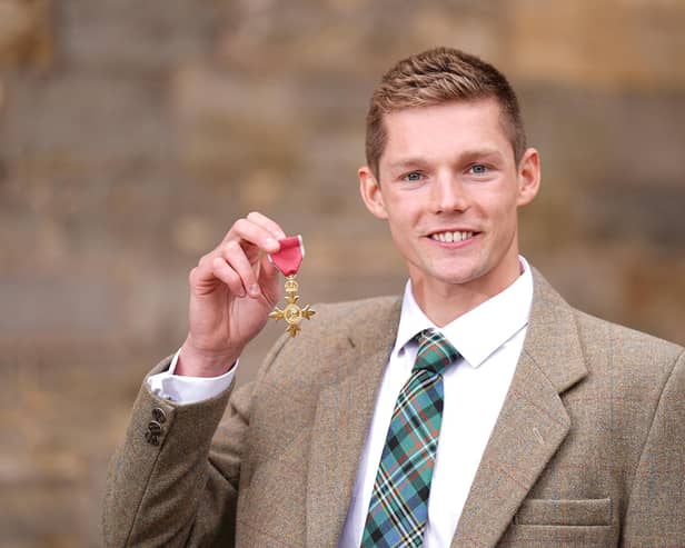 Ex-FIRST swimmer Duncan Scott with his medal after being appointed an Officer of the Order of the British Empire (Photo: Aaron Chown/Getty Images)
