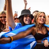 Festival-goers dance and cheer during the TRNSMT Festival on Glasgow Green (Photo by ANDY BUCHANAN/AFP via Getty Images)