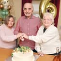 Bankview Care Home residents Pamela Crawford, Bill Jack and Margaret Gowans cut the celebration cake to mark the excellent inspection report. Pic: Michael Gillen