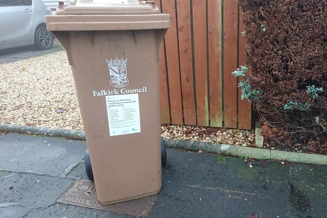 Falkirk Council is to charge for garden waste bin collections, but the charge will be less than originally proposed.