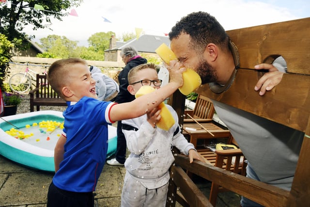 Cousins Nairn and Tommy, both 7,. sponge activities co-ordinator Glen Brown at Thorntree Mews care home carnival
(Picture: Alan Murray, National World)