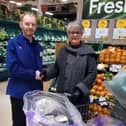Tesco employee Andrew Thompson hands over food to Rev. Monica MacDonald of Martha's Pantry. Pic: Contributed