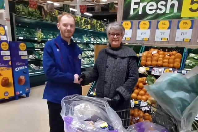 Tesco employee Andrew Thompson hands over food to Rev. Monica MacDonald of Martha's Pantry. Pic: Contributed