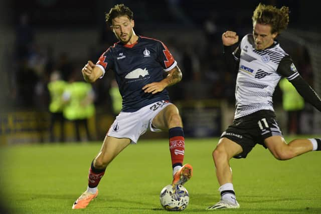 Layton Bisland on the ball for Falkirk against Ayr United's Logan Chalmers during an SPFL Trust Trophy tie (Photo: Michael Gillen)