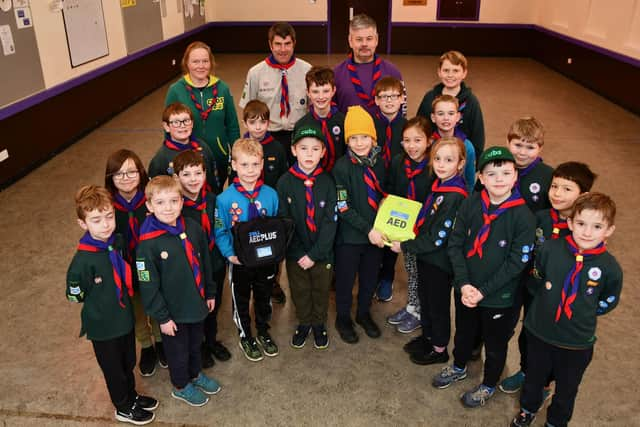 The 16th Laurieston Scout Group has installed an AED (Automated External Defibrillator) outside the Scout Hall. Cubs are pictured with the life-saving equipment.  Pic: Michael Gillen