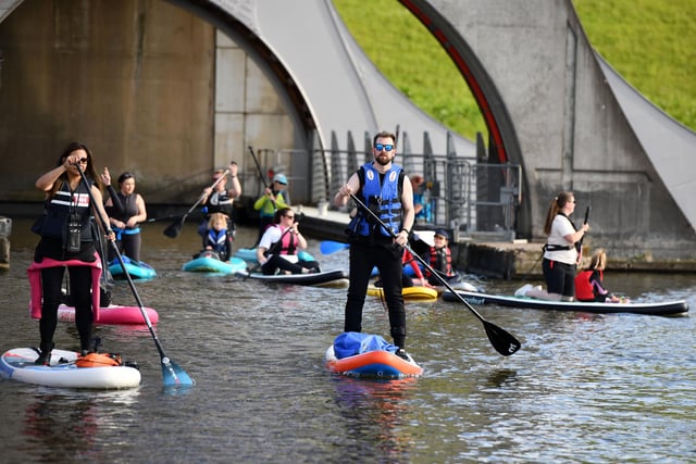 Paddleboarders taking part in SUP in the Sky on the Falkirk Wheel.