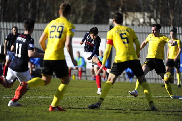 Charlie Telfer fires home the second through a sea of bodies