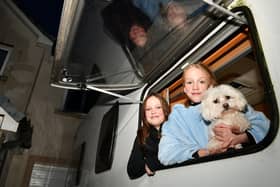 Twins Ayla and Amber Anderson, aged 11, with Bella their four-year-old Maltese dog as the family prepare to spend the night in their motor home as they have a second night of no electricity in Kinnaird. Pic: Michael Gillen