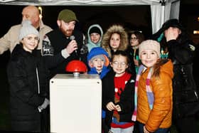 Actor Gary A Wales pushed the button to turn the lights on this year alongside youngsters from Carronshore Primary.  (Pics: Michael Gillen)