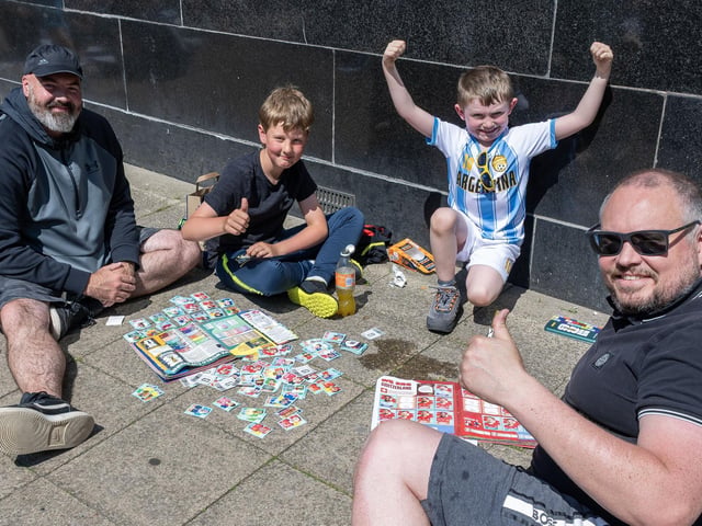 Swapping football stickers.